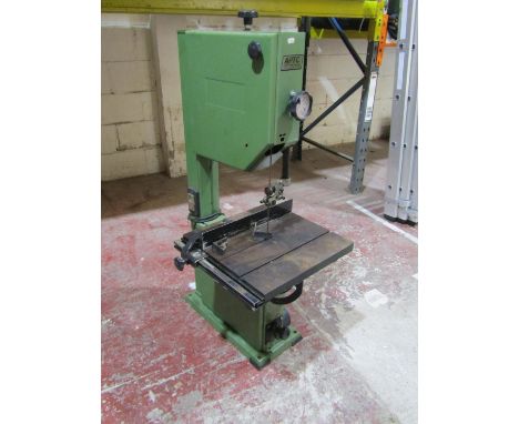 A bench mounted vertical bandsaw labelled APTC, 115cm high 