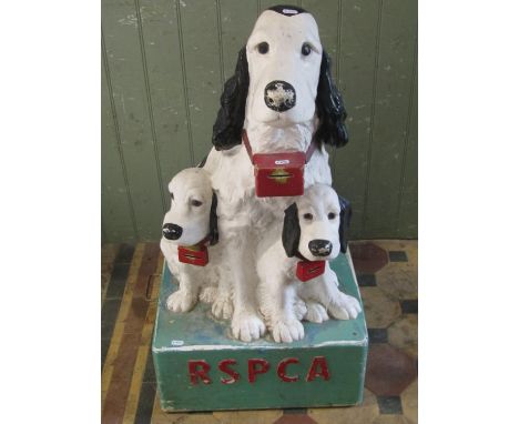 A vintage curb-side collection box for the RSPCA, detailing a spaniel and two puppies on a square cut base, 90cm high x 55cm 
