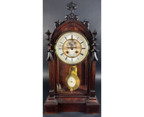 A Victorian mantle clock, the case with gothic tracery outline including pinnacles, enclosing an eight day French striking mo