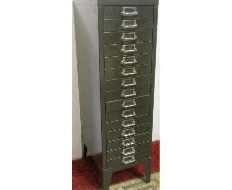 A vintage steel filing cabinet of 15 drawers in an olive green colourway, 30cm wide 