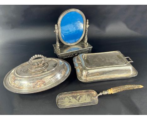 A selection of silver plated table ware including a three piece tea service, two tureens with covers, a silver plated dressin