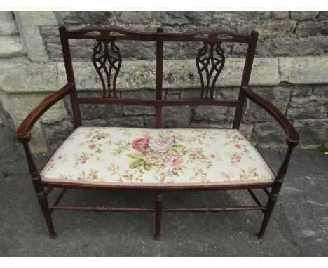 A light weight Edwardian two seat parlour room or bedroom couch with pierced splat back and upholstered seat 