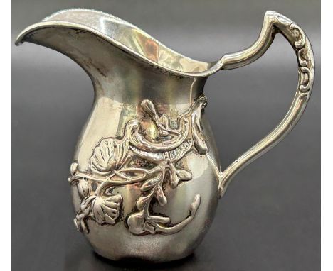 A miniature silver water jug decorated with trailing morning glory to base, Birmingham 1902, makers mark rubbed, 0.7 oz appro