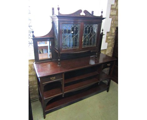 An Edwardian mahogany open sideboard fitted with graduated shelves and two small cupboards, the raised back enclosed by two l