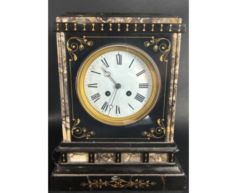 A Victorian black slate and polished marble mantle clock with further gilded highlights, enclosing a French eight day strikin