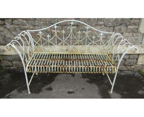 A contemporary but weathered painted aluminium two seat garden bench with scrolled arms, arched back and repeating open scrol