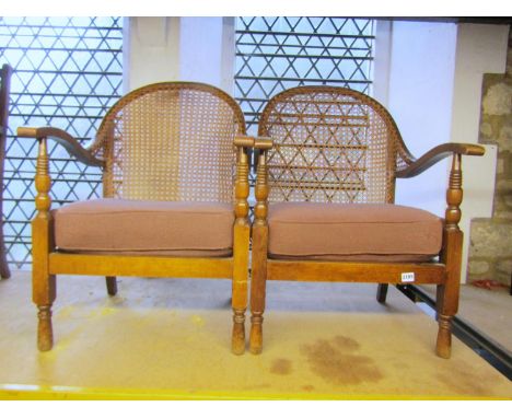 A pair of vintage beechwood bergere armchairs with upholstered loose cushions 