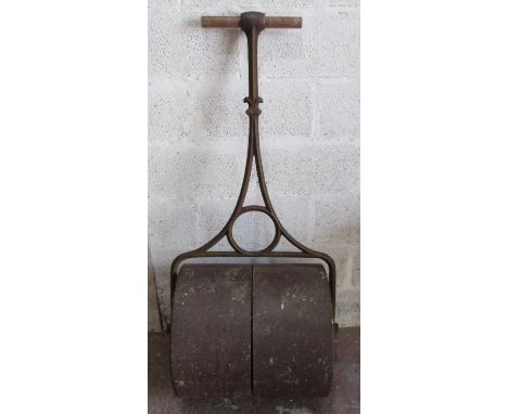 A large cast iron garden lawn roller with decorative pierced drum, 140 cm high, with later tubular handle 
