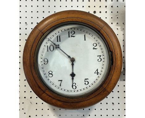 A small dial clock in a moulded oak frame with eight day time piece 
