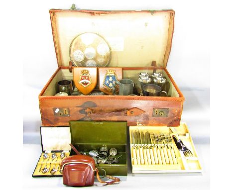 A selection of items contained in a vintage leather suitcase, tankards, goblets, utility cutlery, drinks tray, desk clock, et