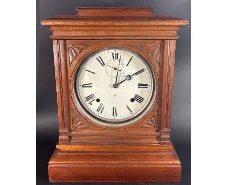 A 19th century American mantle clock by Seth Thomas, the circular dial set within an American oak case with eight day strikin