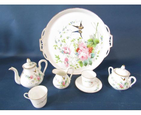 19th century continental cabaret set, the circular tray supporting teapot, two cups, one saucer and a milk jug and sugar basi