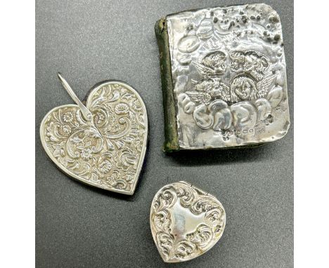A miniature silver lot of decorative silver pieces consisting a book of common prayer with green leather cover and silver fro