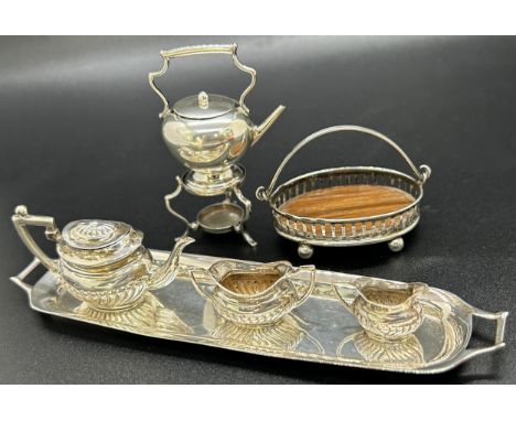A miniature silver tea service consisting of teapot, milk jug, sugar bowl and tea tray, a miniature silver water kettle and s