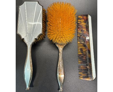 An Art Deco enamelled mirror and brush set with a single comb, a scrolled silver handled mirror, two silver capped glass jars