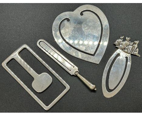 A sterling silver collection of money clips in various designs and shapes inducing a heart shaped example, an oval shaped exa