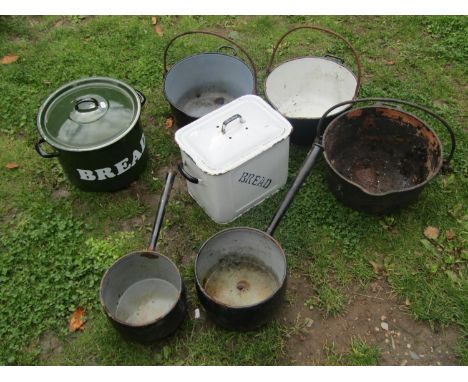 Five vintage cast iron and enamel kitchen pans of varying size, three with loose loop handles, together with two enamel bread