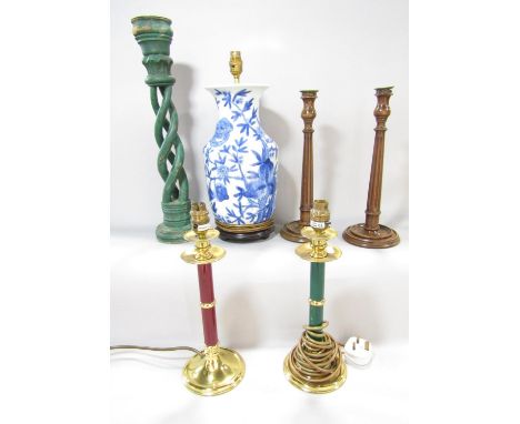 A selection of lamps, including a pair of reeded wood candlestick lamps, a red and green lamps with brass sconces, a blue and