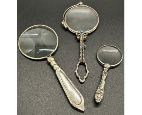 A collection of silver stylish looking glasses, including a pair of lorgnettes with decorative marcasite gems to the handle a