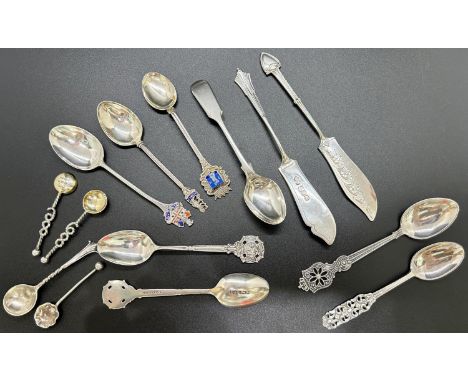 A group of silver collectable cutlery including a pair of apostle salt spoons, 3 enamel vintage travel spoons, two fish knive