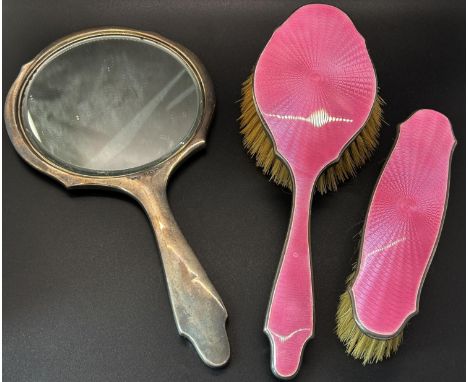 A pink enamelled hand mirror, hair brush and clothes brush with silver edging, a single silver filigree buckle, a pusher and 