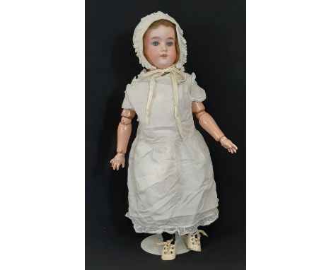 Early 20th century German bisque head doll by Armand Marseille, with closing blue eyes, open mouth with teeth and jointed com