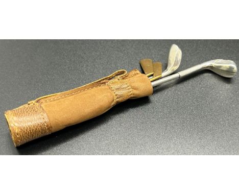 A sterling silver manicure set in the form of golf clubs with miniature golf bag, total weight 0.5 oz approx 