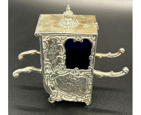 A silver Sedan chair salt  in scrolled floral design, blue glass interior, imported item, weight 1.4 oz approx 
