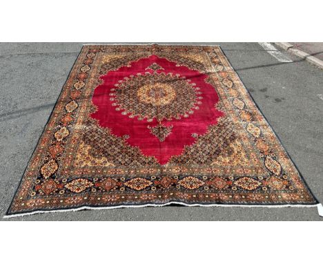 A good quality North East Persian Moud carpet, with an elaborate central spandrel of flowers on a red ground and repeating bo