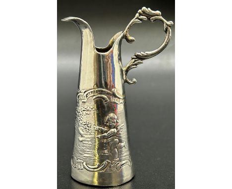 A miniature silver wine pitcher/jug decorated with a scene of cherubs by the riverside, London  1901, maker Elly Isaac Miller