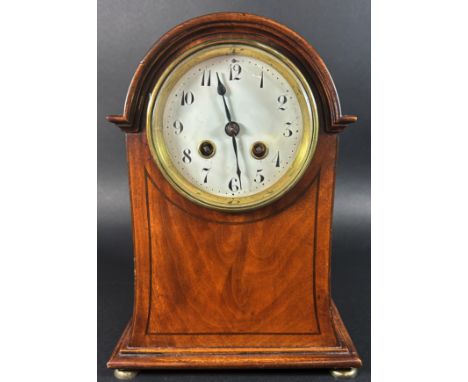 An Edwardian mahogany mantle clock, the case with swept outline and string banded inlay, enclosing an eight day striking move