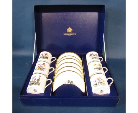 A cased set of six Royal Worcester floral patterned coffee cans and saucers 