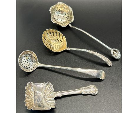 Four silver sugar sifter in various designs including one in the form of a shell with floral design handle, a further example
