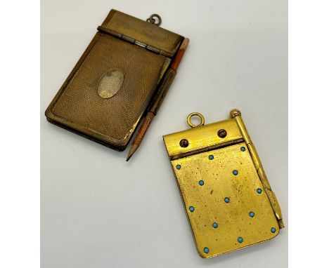 A gold plated pocket notebook inlaid with turquoise and a further example with engine turned detail, 