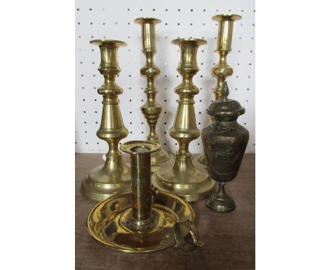 Two pairs of brass candlesticks, a single brass chamber stick, a brass snail, six brass patisserie moulds, a brass dish, and 