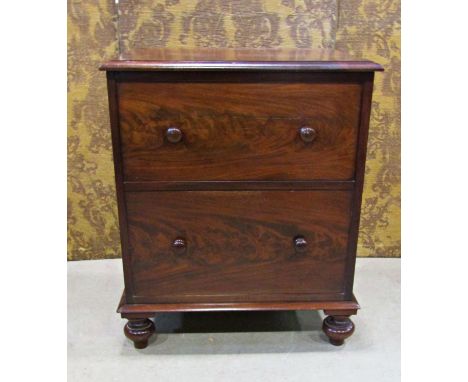 A Georgian mahogany commode with rising lid, the front elevation presented  as two drawers on bun supports, together with a f