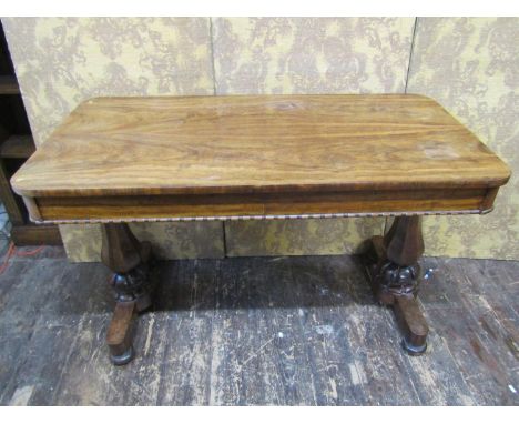 A 19th century rosewood console table with tablet shaped top, with carved frieze over tapering carved supports, 73cm high, 12