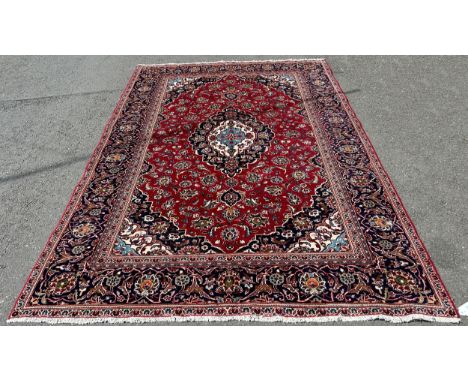 A good quality Central Persian Kashan carpet, with a central blue floral medallion and stylised flowers to the  borders, 292 