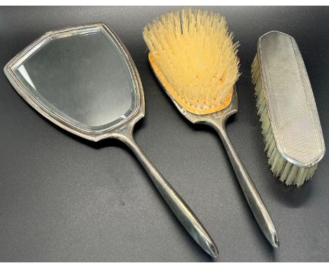 An engine turned silver brush mirror and comb set, five teaspoons, two napkin rings and a single commemorative teaspoon stamp