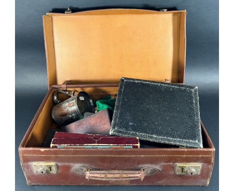 A vintage suitcase containing loose silver plated flatware, a cased set of fish knives and forks, a tankard, a pair of Georgi
