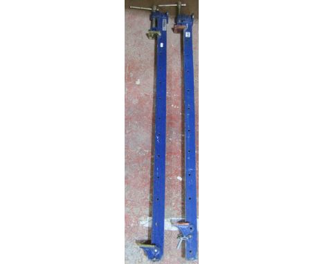 A pair of painted iron sash clamps, labelled Nutools, each measuring 123cm 