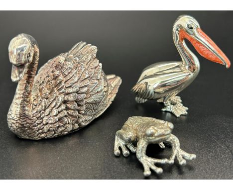 A collection of silver miniatures comprising a swan, a frog, a pelican with enamel beak and a gun, total weight 2oz approx
