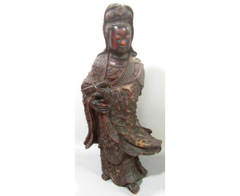 A Chinese carved wood Guanyin figure wearing intricately carved robes, holding a scroll, 45cm tall 