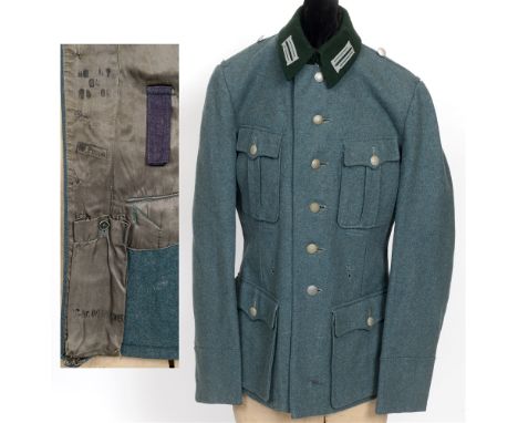 DAS DEUTSCHE HEER - FIELD SERVICE TUNIC  of four-pocket green wool/rayon construction with a dark green lay down collar, feat