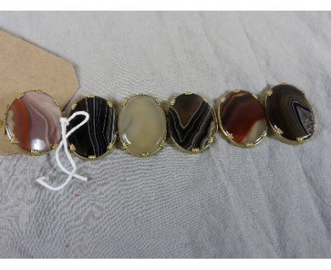 A Victorian Scottish agate bangle, fitted with four multi coloured roundels