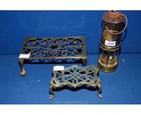 Two brass stands and a miner's Lamp.
