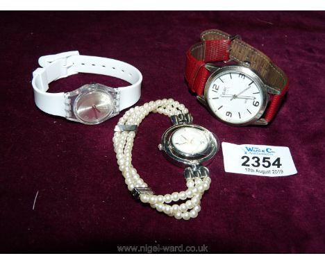 Three ladies wristwatches including a Swatch watch.