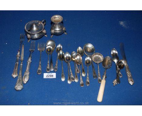 A quantity of silver plated cutlery including mustard pot, silver handled pickle fork, etc.