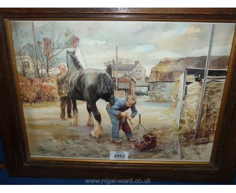 A wooden framed print of a 'Blacksmith at work' by Edward Straker.
