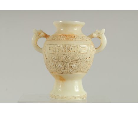 A CHINESE CARVED WHITE JADE TWO HANDLED VASE. 7ins high.